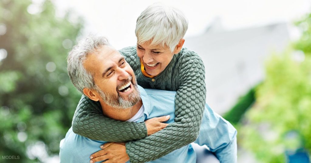 An older couple giving a piggy back ride (models)