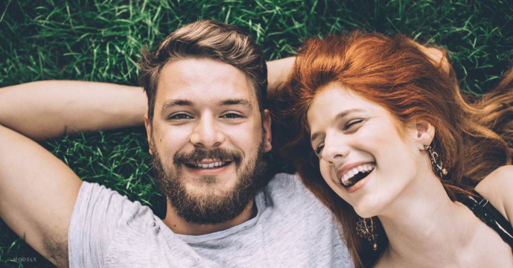 Couple lying down smiling