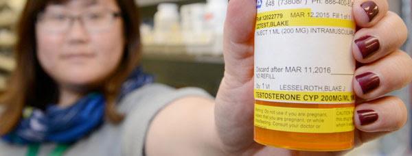 Woman holding prescription pill bottle