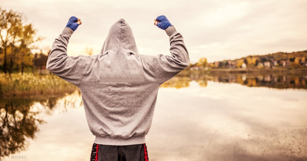 A man who receives hormone replacement therapy treatment looks out over a pond during a run.