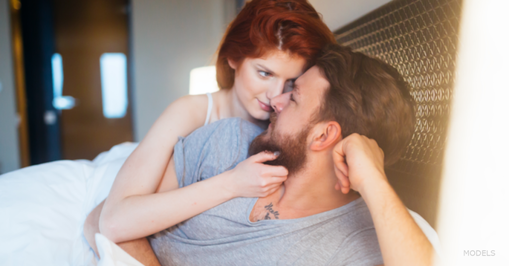 A man and a woman look each other in the eyes.