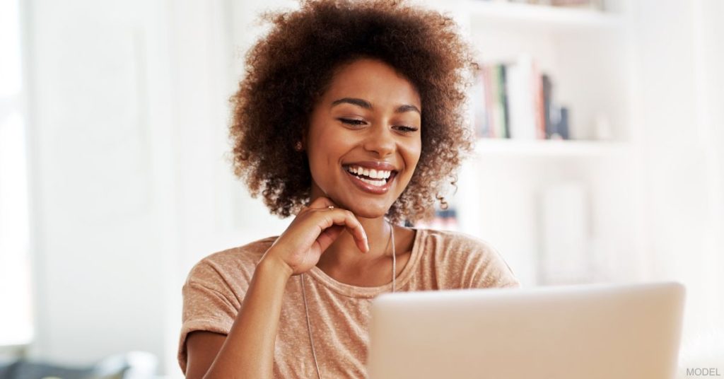 A woman looking at her laptop (model)